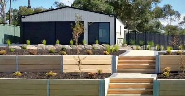 Finished backyard with concrete sleeper retaining wall, steps and new lawn in Adelaide