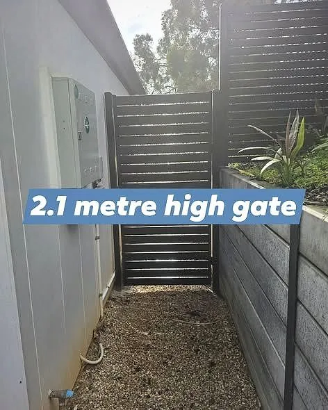 2.1 metre high slat gate between house and fence